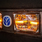 Close-up of a vehicle's headlight with a visible brand logo.