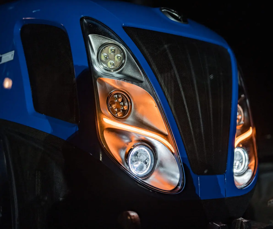 Close-up of a vehicle's headlight with a blue and black design.