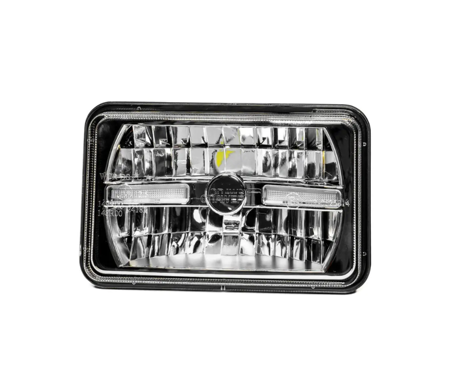 Car headlight with clear lens and black frame on a white background